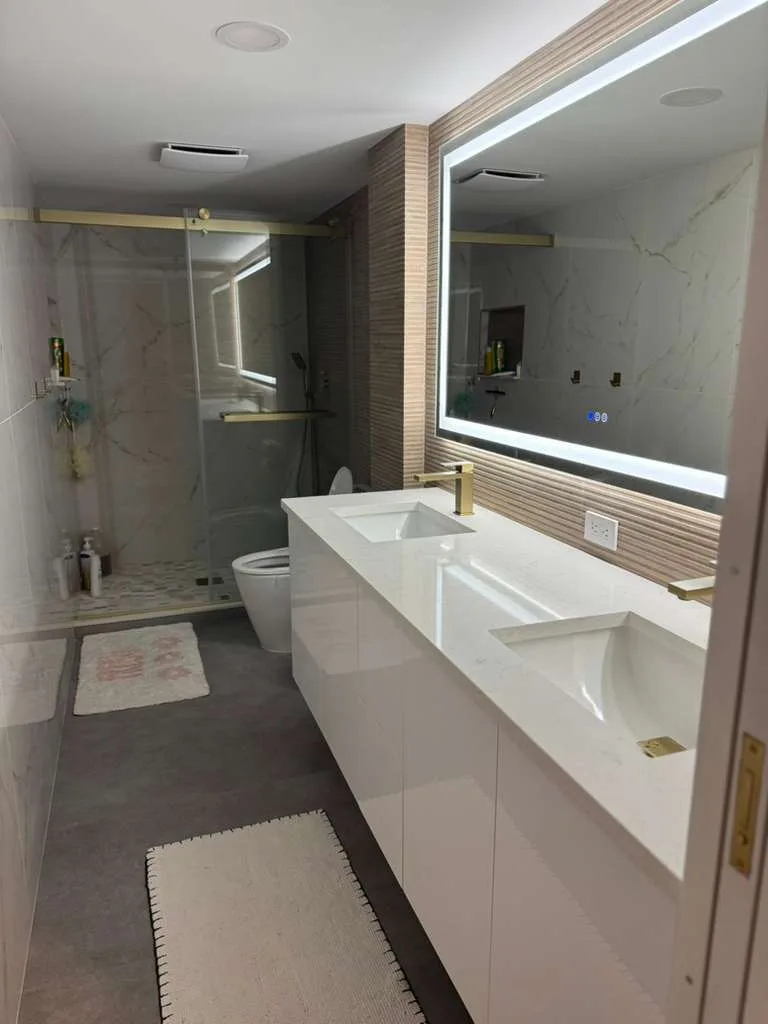 Marble master bathroom with LED mirror accent wall