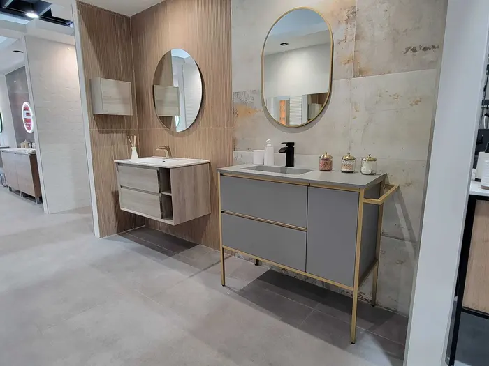 Professional bathroom vanity showroom display featuring multiple sink configurations with wood, stone, and ceramic finishes.